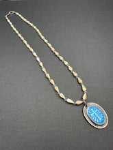 Load image into Gallery viewer, Enameled cross on a beaded mother of pearl and crystal necklace.