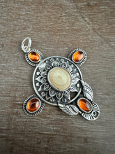 Load image into Gallery viewer, Fossilized walrus and garnets pendant.