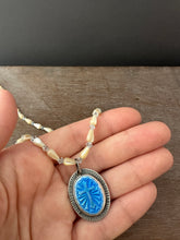 Load image into Gallery viewer, Enameled cross on a beaded mother of pearl and crystal necklace.