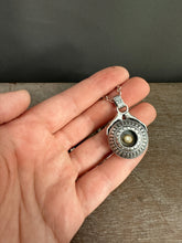 Load image into Gallery viewer, Hands holding a moissanite set in 22k gold