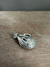 Load image into Gallery viewer, Hands holding a moissanite set in 22k gold