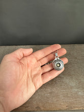 Load image into Gallery viewer, Hands holding a moissanite set in 22k gold