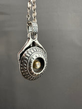 Load image into Gallery viewer, Hands holding a moissanite set in 22k gold