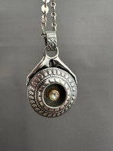 Load image into Gallery viewer, Hands holding a moissanite set in 22k gold