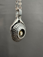 Load image into Gallery viewer, Hands holding a moissanite set in 22k gold