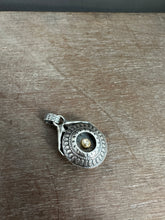 Load image into Gallery viewer, Hands holding a moissanite set in 22k gold