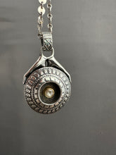 Load image into Gallery viewer, Hands holding a moissanite set in 22k gold