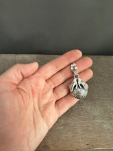 Load image into Gallery viewer, Hands holding a moissanite set in 22k gold