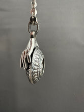 Load image into Gallery viewer, Hands holding a moissanite set in 22k gold