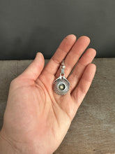 Load image into Gallery viewer, Hands holding a moissanite set in 22k gold