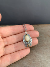 Load image into Gallery viewer, Fossilized mastodon ivory and tanzanite set in 22k gold charm necklace