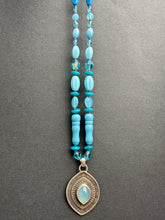 Load image into Gallery viewer, Layered silver and Aquamarine eye pendant with hand knotted vintage glass beads
