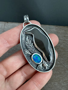 Obsidian crow with an opal