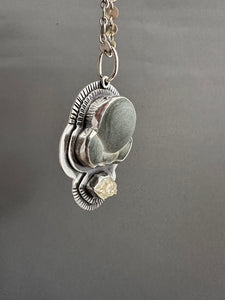 Fairy stone and quartz crystal pendant