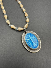 Load image into Gallery viewer, Enameled cross on a beaded mother of pearl and crystal necklace.
