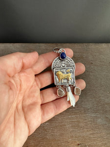 Golden Lion with Herkimer quartz, lapis, and a shell hand