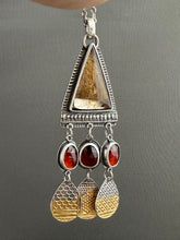 Load image into Gallery viewer, Golden rutilated quartz with garnets.
