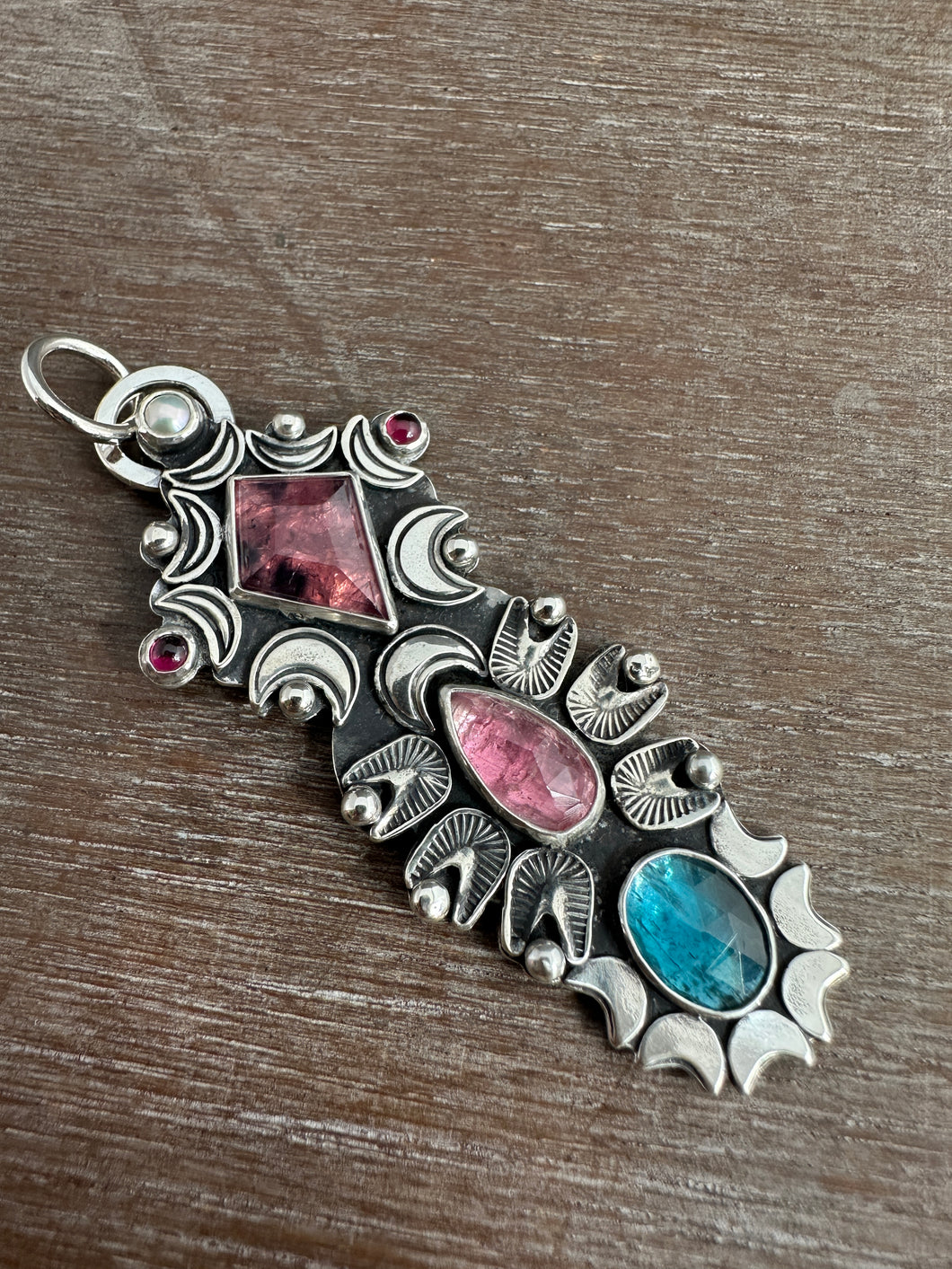 Multi stone pendant with a Winza Sapphire, Tourmaline, Kyanite, Garnets, and a Pearl