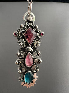 Multi stone pendant with a Winza Sapphire, Tourmaline, Kyanite, Garnets, and a Pearl