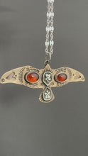 Load and play video in Gallery viewer, Bronze and silver stamped bird pendant with garnets
