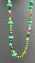 Load and play video in Gallery viewer, Vintage glass bead silk knotted necklace in greens and oranges

