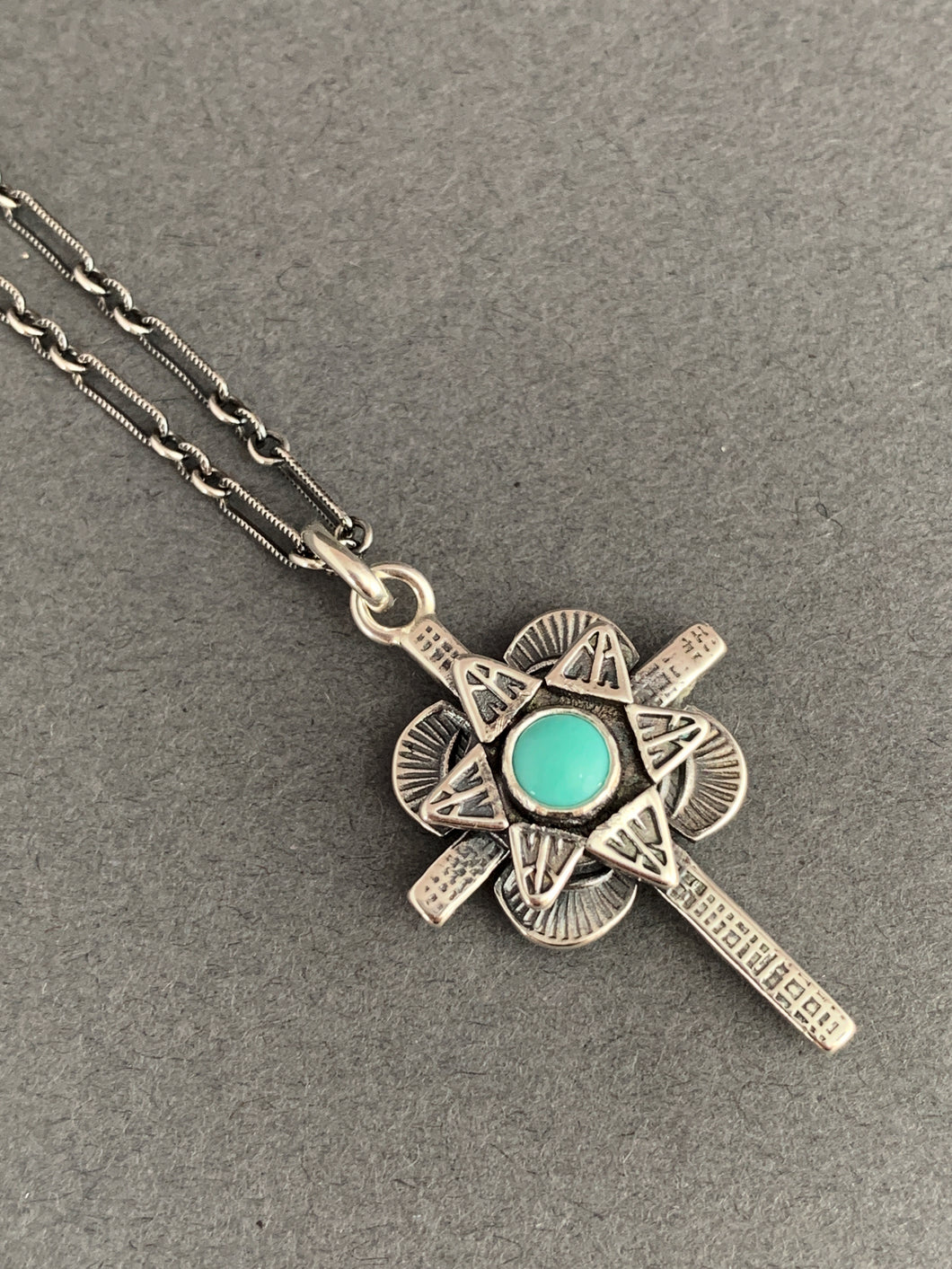 Small turquoise cross