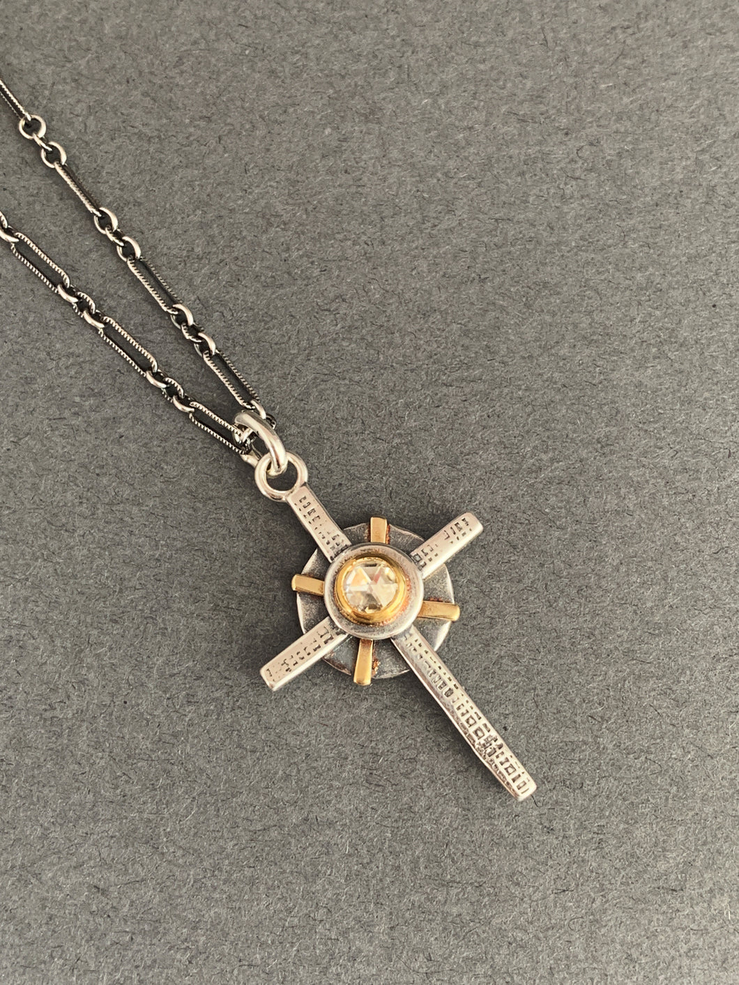 Small moissanite and gold cross