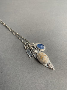 Fossilized sand dollar and kyanite charm necklace