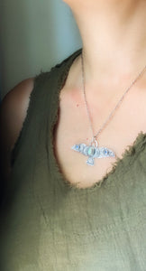 Large labradorite and kyanite stamped bird pendant