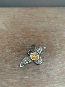 Small golden sun stamped bird pendant