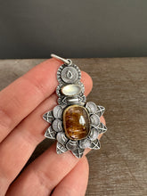 Load image into Gallery viewer, Cacoxenite and moonstone set in 22k gold medallion

