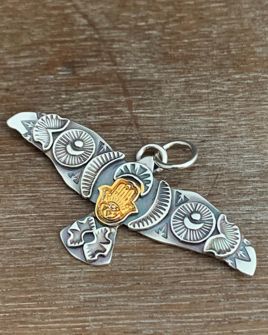 Large golden hamsa stamped bird pendant