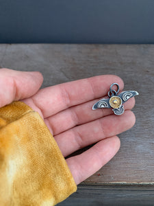 Small golden sun stamped bird pendant