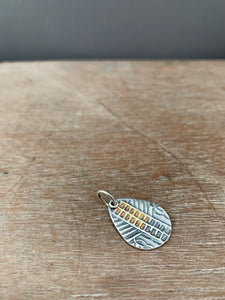 Silver and gold ladder pattern charm