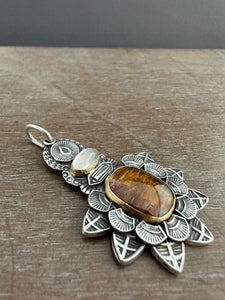 Cacoxenite and moonstone set in 22k gold medallion