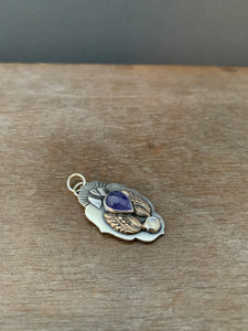 Small winged tanzanite with moonstone pendant