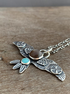 Large chocolate moonstone stamped bird pendant