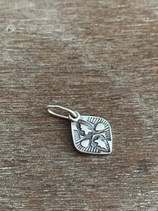 Tiny stamped silver charm