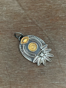 Golden eye and sun pendant