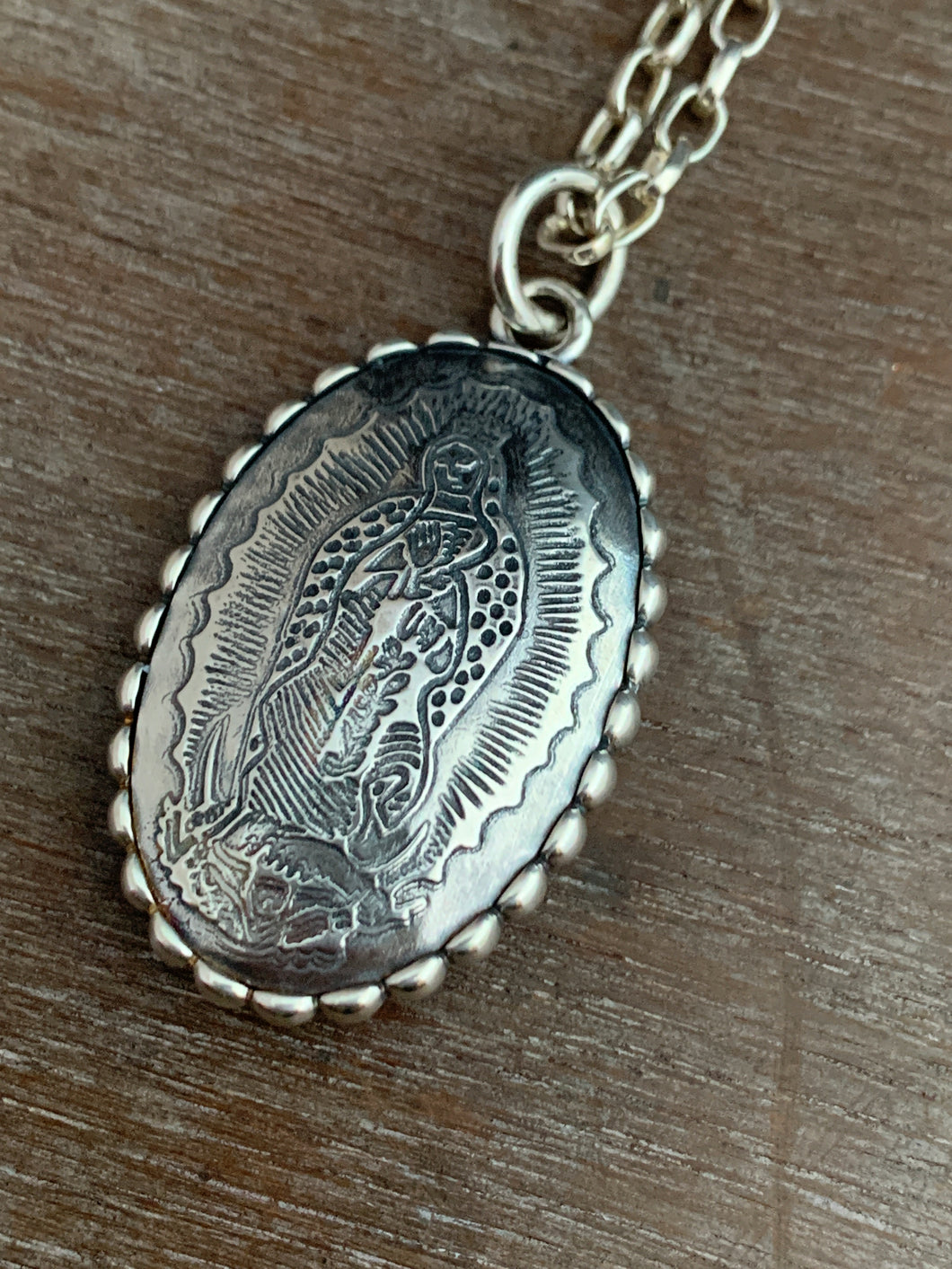 Blue sapphire and Our Lady of Guadalupe pendant