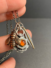 Load image into Gallery viewer, Honey comb charm necklace, Hessonite garnet set in 22k gold, with a bronze bee, and feather with an 18k gold accent
