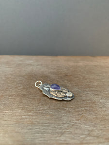 Small winged tanzanite with moonstone pendant