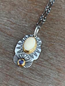 Fossilized mastodon ivory and tanzanite set in 22k gold charm necklace